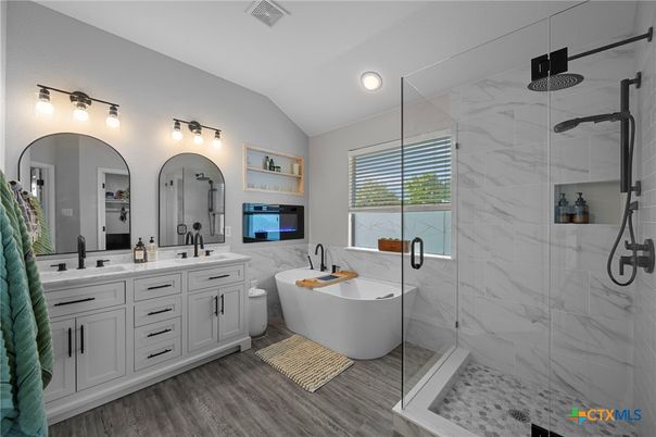 Bathroom, Dual Sink Vanities, Free Standing Baths, Glass Shower, Interior, Marble Walls, Recessed Lighting, Wood Texture Flooring