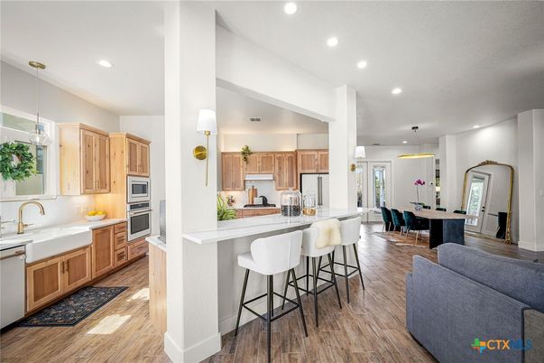 Dining room, Interior, Kitchen, Pendant Lights, Recessed Lighting, Stainless Steel Appliances, Wood Texture Flooring