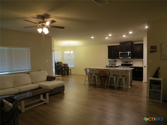 Chandelier, Dining room, Interior, Kitchen, Living room, Pendant Lights, Recessed Lighting, Stainless Steel Appliances, Wood Texture Flooring