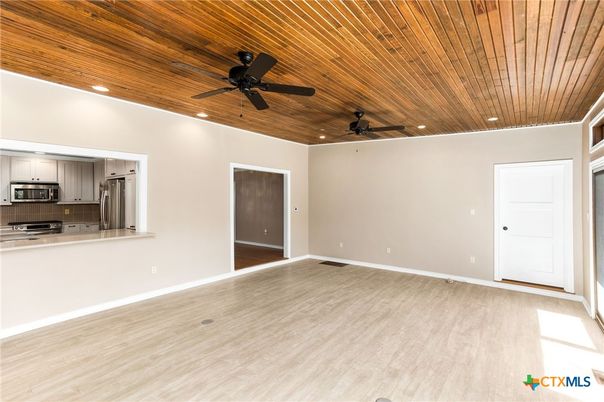 Empty room, Interior, Kitchen, Recessed Lighting, Stainless Steel Appliances, Wooden Ceilings, Wood Texture Flooring