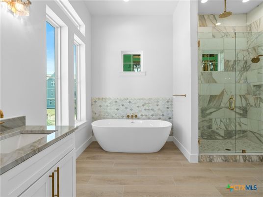 Bathroom, Free Standing Baths, Glass Shower, Interior, Marble Walls, Recessed Lighting, Wood Texture Flooring