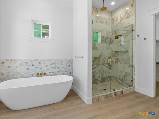 Bathroom, Free Standing Baths, Glass Shower, Interior, Marble Walls, Recessed Lighting, Wood Texture Flooring
