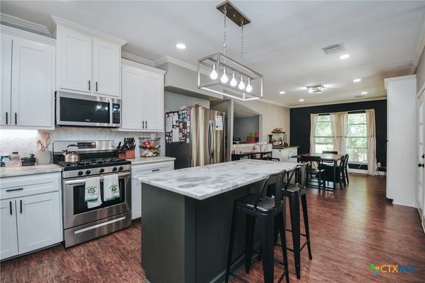 Dining room, Interior, Kitchen, Pendant Lights, Recessed Lighting, Stainless Steel Appliances, Wood Texture Flooring