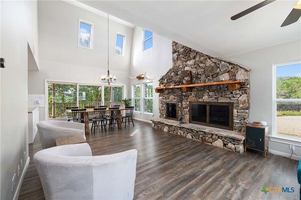Chandelier, Dining room, Fireplace, Interior, Pendant Lights, Stone Walls, Wood Texture Flooring