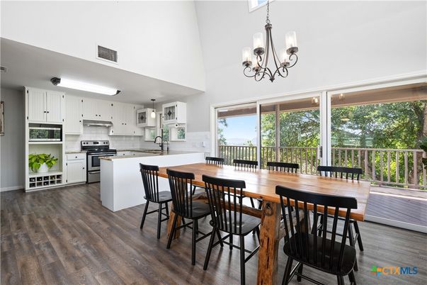Chandelier, Dining room, Interior, Kitchen, Pendant Lights, Stainless Steel Appliances, Wood Texture Flooring