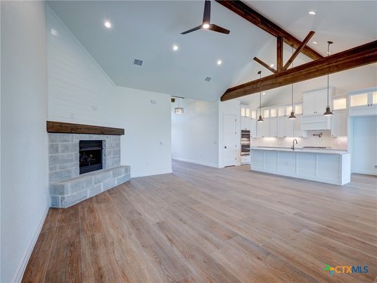 Empty room, Fireplace, Interior, Kitchen, Pendant Lights, Recessed Lighting, Wooden Beams, Wood Texture Flooring