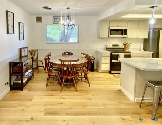 Chandelier, Dining room, Interior, Kitchen, Pendant Lights, Stainless Steel Appliances, Wood Texture Flooring