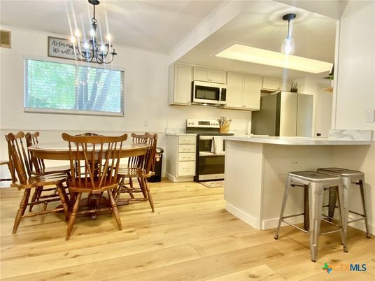 Chandelier, Dining room, Interior, Kitchen, Pendant Lights, Stainless Steel Appliances, Wood Texture Flooring