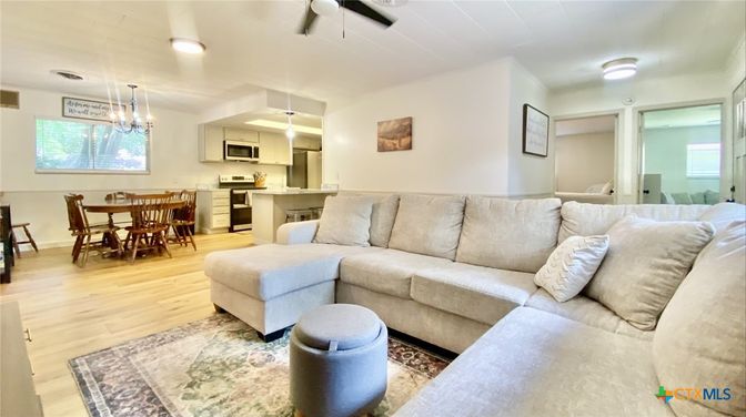 Chandelier, Dining room, Interior, Kitchen, Living room, Pendant Lights, Recessed Lighting, Stainless Steel Appliances, Wood Texture Flooring