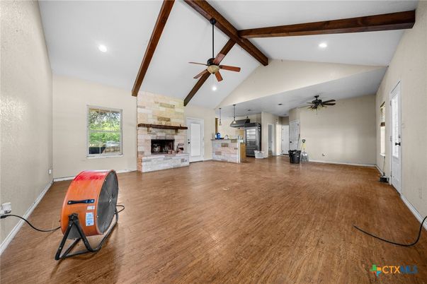 Empty room, Fireplace, Interior, Recessed Lighting, Stone Walls, Wooden Beams, Wood Texture Flooring