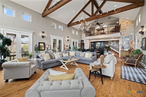 Chandelier, Fireplace, Interior, Living room, Recessed Lighting, Stone Walls, Wooden Beams, Wood Texture Flooring
