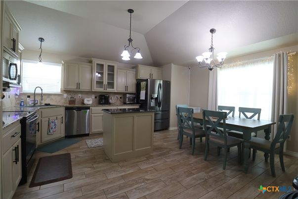 Chandelier, Dining room, Interior, Kitchen, Pendant Lights, Stainless Steel Appliances, Wood Texture Flooring
