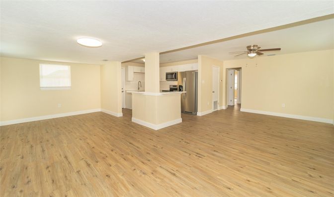 Empty room, Interior, Kitchen, Stainless Steel Appliances, Wood Texture Flooring