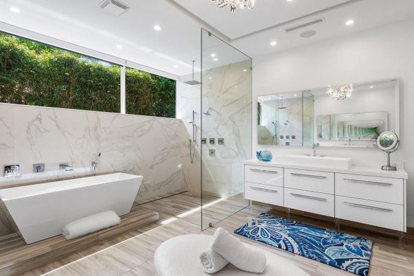 Bathroom, Dual Sink Vanities, Free Standing Baths, Glass Shower, Interior, Marble Walls, Recessed Lighting, Wood Texture Flooring