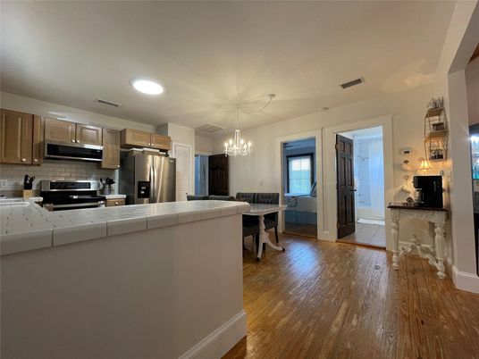 Chandelier, Dining room, Interior, Kitchen, Recessed Lighting, Stainless Steel Appliances, Wood Texture Flooring