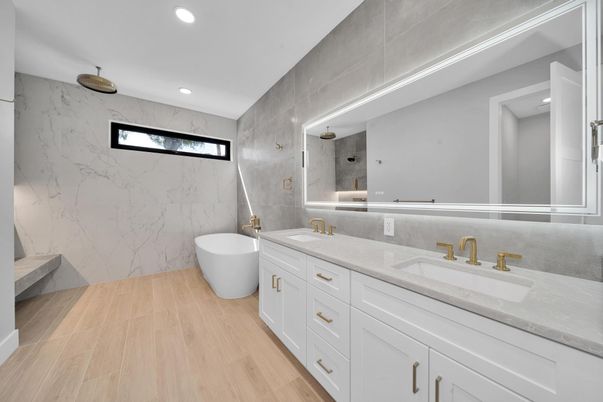 Bathroom, Dual Sink Vanities, Free Standing Baths, Interior, Marble Walls, Recessed Lighting, Wood Texture Flooring