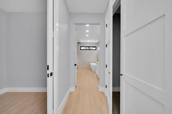 Bathroom, Free Standing Baths, Interior, Marble Walls, Recessed Lighting, Wood Texture Flooring