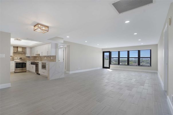 Empty room, Interior, Kitchen, Recessed Lighting, Stainless Steel Appliances, Wood Texture Flooring