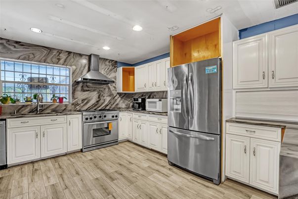 Interior, Kitchen, Marble Walls, Recessed Lighting, Stainless Steel Appliances, Wood Texture Flooring