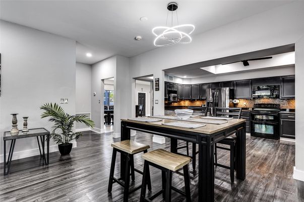 Dining room, Interior, Kitchen, Pendant Lights, Recessed Lighting, Stainless Steel Appliances, Wood Texture Flooring