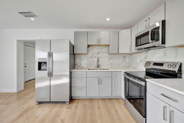 Interior, Kitchen, Marble Walls, Recessed Lighting, Stainless Steel Appliances, Wood Texture Flooring