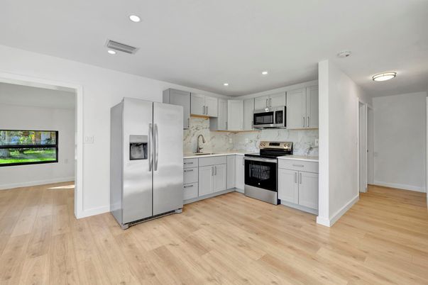 Interior, Kitchen, Marble Walls, Recessed Lighting, Stainless Steel Appliances, Wood Texture Flooring