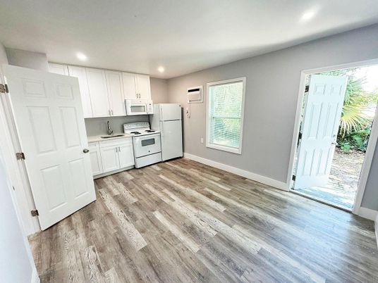 Interior, Kitchen, Recessed Lighting, Washer, Wood Texture Flooring