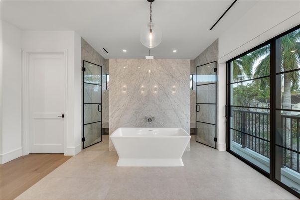 Bathroom, Free Standing Baths, Glass Shower, Interior, Marble Walls, Pendant Lights, Recessed Lighting, Wood Texture Flooring