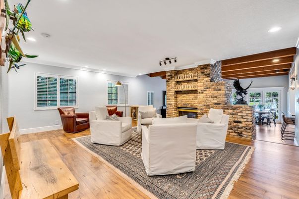 Dining room, Fireplace, Interior, Living room, Recessed Lighting, Stone Walls, Wood Texture Flooring