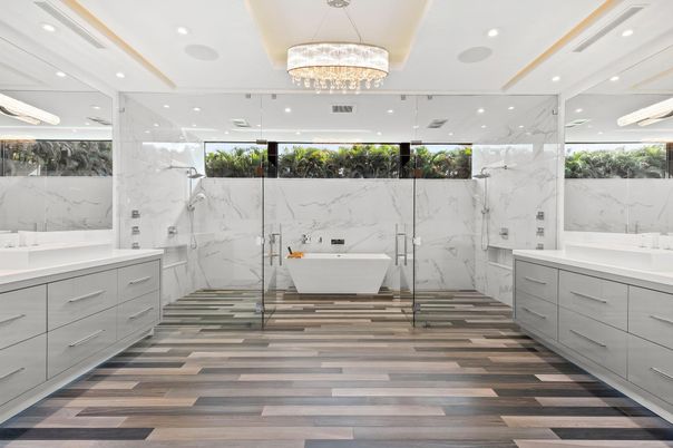 Bathroom, Chandelier, Free Standing Baths, Glass Shower, Interior, Marble Walls, Recessed Lighting, Wood Texture Flooring