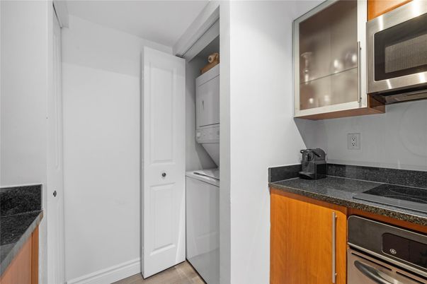 Interior, Kitchen, Stainless Steel Appliances, Tile Countertops, Washer, Wood Texture Flooring