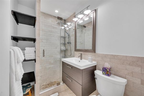 Bathroom, Free Standing Baths, Glass Shower, Interior, Recessed Lighting, Stone Walls
