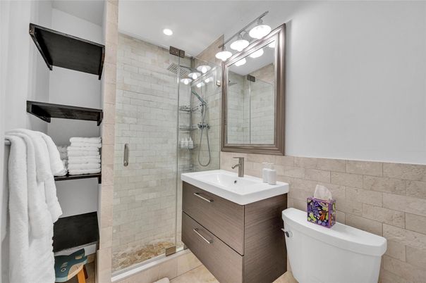 Bathroom, Free Standing Baths, Glass Shower, Interior, Recessed Lighting, Stone Walls