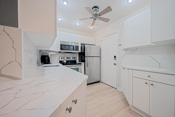 Interior, Kitchen, Marble Walls, Recessed Lighting, Stainless Steel Appliances, Wood Texture Flooring