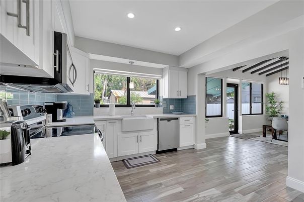 Dining room, Interior, Kitchen, Pendant Lights, Recessed Lighting, Stainless Steel Appliances, Wood Texture Flooring