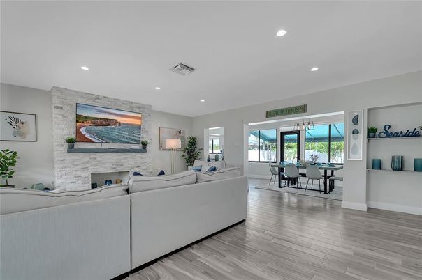 Dining room, Fireplace, Interior, Living room, Recessed Lighting, Stone Walls, Wood Texture Flooring