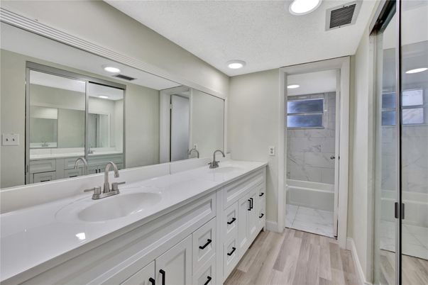 Bathroom, Dual Sink Vanities, Interior, Marble, Marble Walls, Recessed Lighting, Wood Texture Flooring
