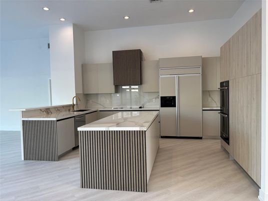 Interior, Kitchen, Marble Walls, Recessed Lighting, Stainless Steel Appliances, Wood Texture Flooring
