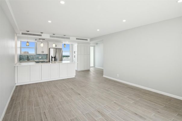 Empty room, Interior, Kitchen, Pendant Lights, Recessed Lighting, Stainless Steel Appliances, Wood Texture Flooring