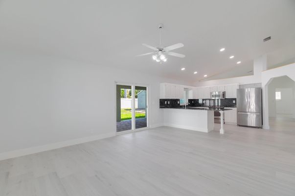 Empty room, Interior, Kitchen, Recessed Lighting, Stainless Steel Appliances, Wood Texture Flooring