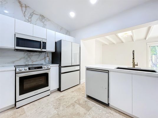 Interior, Kitchen, Marble Walls, Recessed Lighting, Stainless Steel Appliances