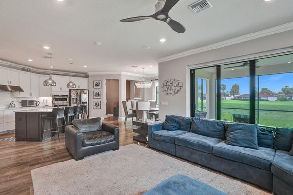 Chandelier, Dining room, Interior, Kitchen, Living room, Pendant Lights, Recessed Lighting, Stainless Steel Appliances, Wood Texture Flooring