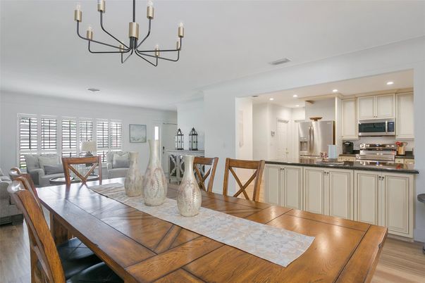 Chandelier, Dining room, Interior, Kitchen, Living room, Recessed Lighting, Stainless Steel Appliances, Wood Texture Flooring
