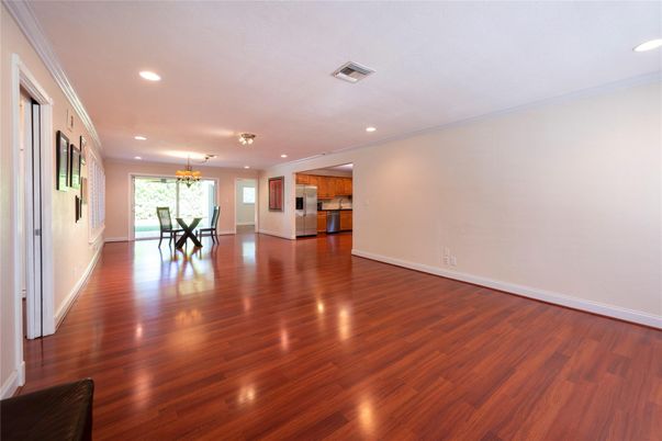 Chandelier, Dining room, Empty room, Interior, Kitchen, Recessed Lighting, Stainless Steel Appliances, Wood Texture Flooring