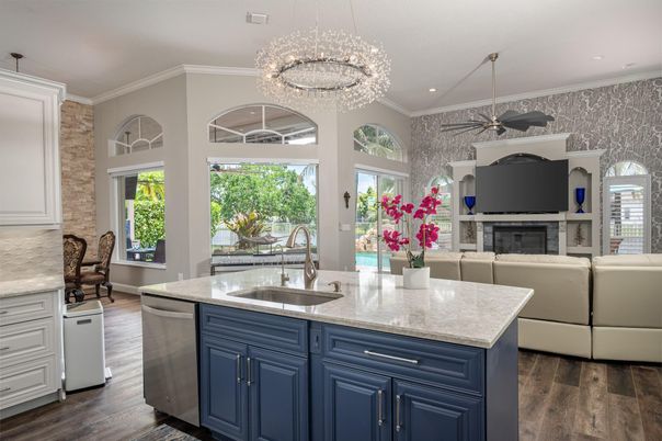 Chandelier, Fireplace, Interior, Kitchen, Living room, Recessed Lighting, Stone Walls, Wood Texture Flooring