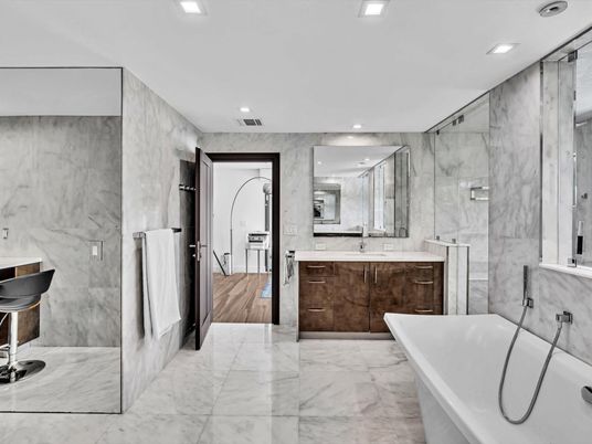 Bathroom, Dual Sink Vanities, Free Standing Baths, Interior, Marble, Marble Walls, Recessed Lighting, Wood Texture Flooring