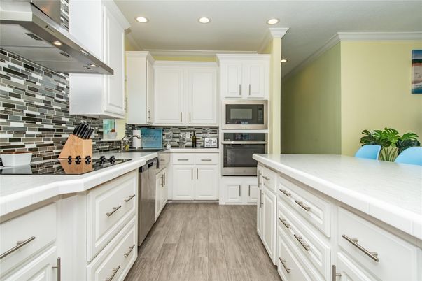 Interior, Kitchen, Recessed Lighting, Stainless Steel Appliances, Tile Countertops, Wood Texture Flooring