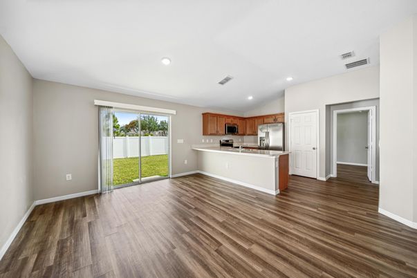 Empty room, Interior, Kitchen, Recessed Lighting, Stainless Steel Appliances, Wood Texture Flooring