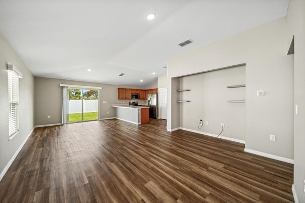 Empty room, Interior, Kitchen, Recessed Lighting, Stainless Steel Appliances, Wood Texture Flooring