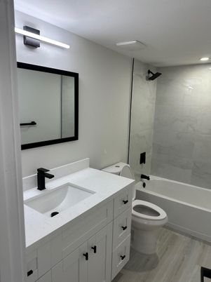 Bathroom, Dual Sink Vanities, Interior, Marble Walls, Recessed Lighting, Wood Texture Flooring